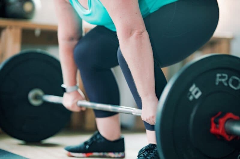 A group class warming up with barbells